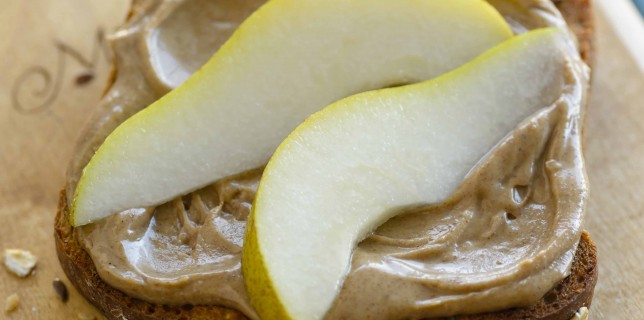 Whole wheat toast topped with peanut butter and sliced pears